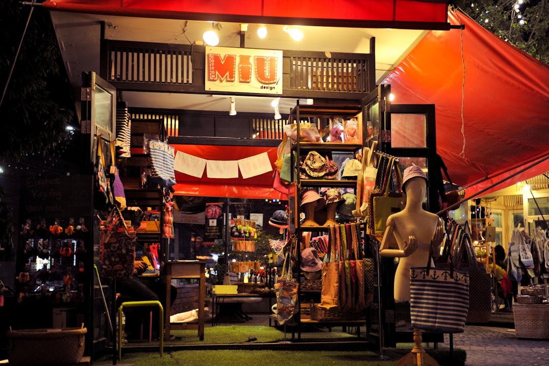 A small shop selling hats and accessories at night.